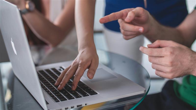Laptop screen displaying the Verimpact ESG platform dashboard. The interface shows company sustainability metrics including stakeholder and materiality status with a circular progress chart, company member bar chart, and data collection indicators for environmental, social, and governance categories.